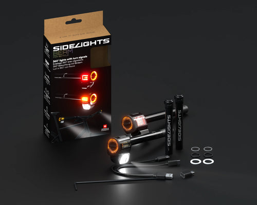 Coffret complet SideLights Beam sur fond anthracite : boîte, deux éclairages, deux batteries et accessoires
